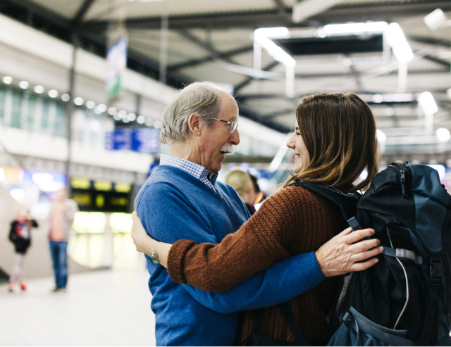 Man and woman hugging at airport